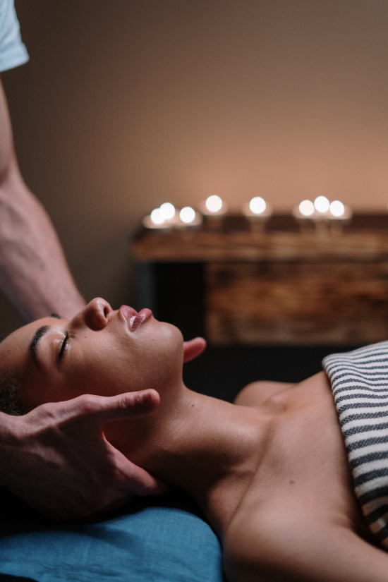 Massage du cou d'une femme allongée sur le dos